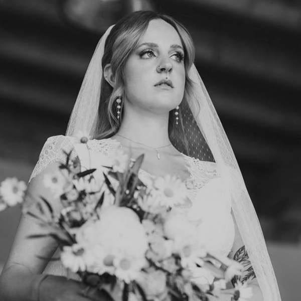 Braut mit Schleier und Blumenstrauß